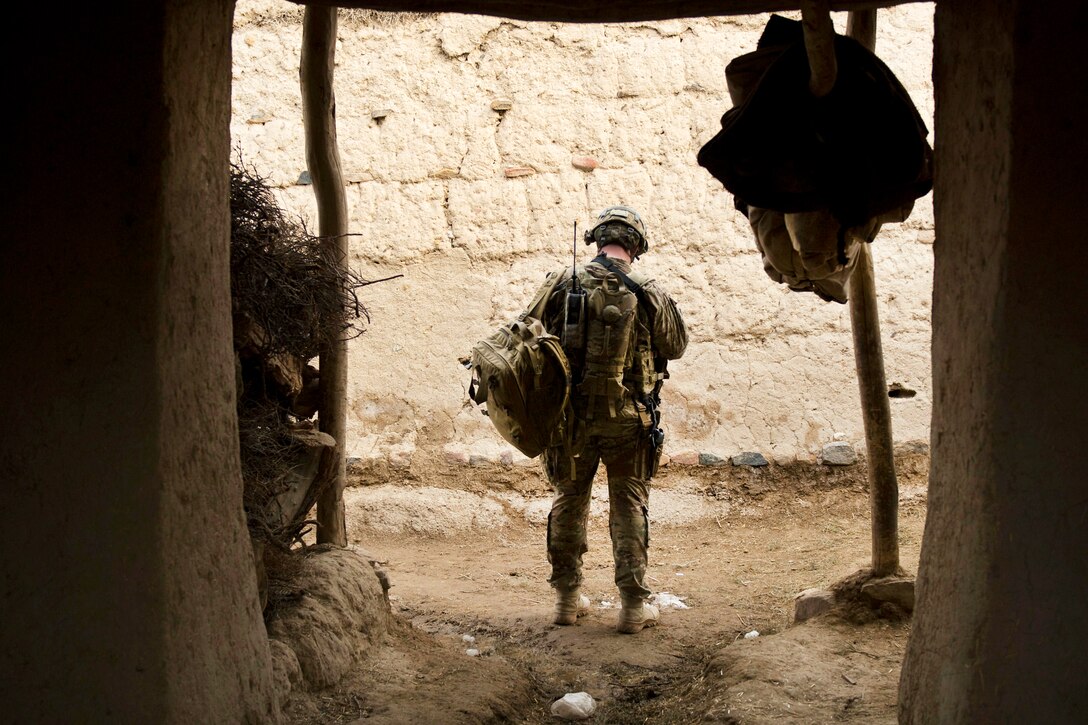 U.S. Army Staff Sgt. Jacob Pries pauses to check a global positioning system during a search of the Qual-e Jala village, in Afghanistan, Feb. 21, 2011. Pries is an engineer assigned to the 34th Infantry Division's 2nd Brigade Combat Team, Headquarters Company, 1st Squadron, 113th Cavalry Regiment, Task Force Redhorse.