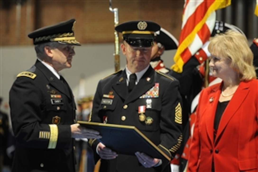 Sergeant Major of the Army Kenneth O. Preston receives an award during his retirement ceremony from Chief of Staff of the Army Gen. George W. Casey Jr. at Fort Meyer, Va., on March 1, 2011.  Preston served in the Army for 36 years and was the longest-serving sergeant major of the Army.  