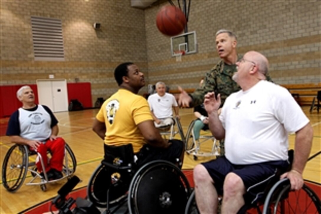 Marine Corps Commandant Gen. James F. Amos throws the tip-off to retired Marines competing in a wheelchair basketball game at Paige Field House, on Camp Pendleton, Calif., Feb. 25, 2011. Winners will compete in the Wounded Warrior Games in May. 