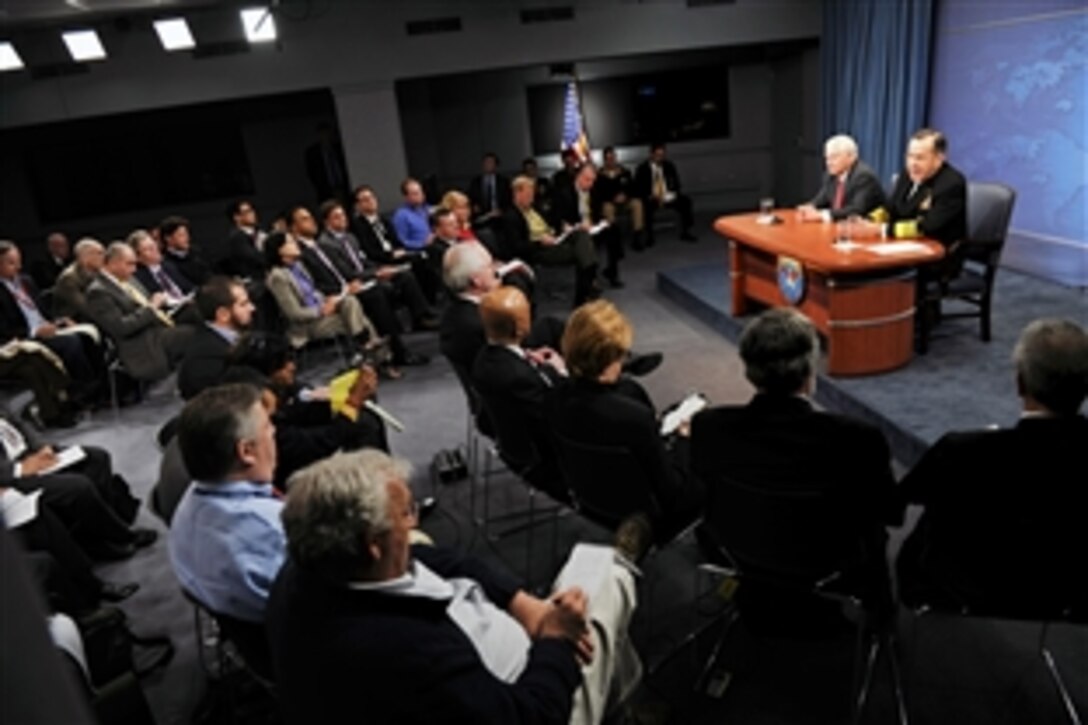 Navy Adm. Mike Mullen, chairman of the Joint Chiefs of Staff, responds to a reporter's question during a press conference with Defense Secretary Robert M. Gates at the Pentagon, March 1, 2011.