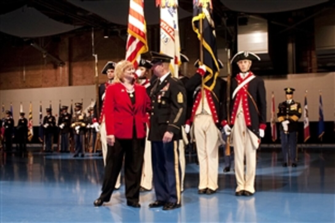 Sgt. Major of the Army Kenneth O. Preston and his wife, Karen, react to applause for their service to the country during his retirement ceremony on Fort Meyer, Va., March, 1, 2011. Preston served in the Army for 36 years and was its longest-serving sergeant major.