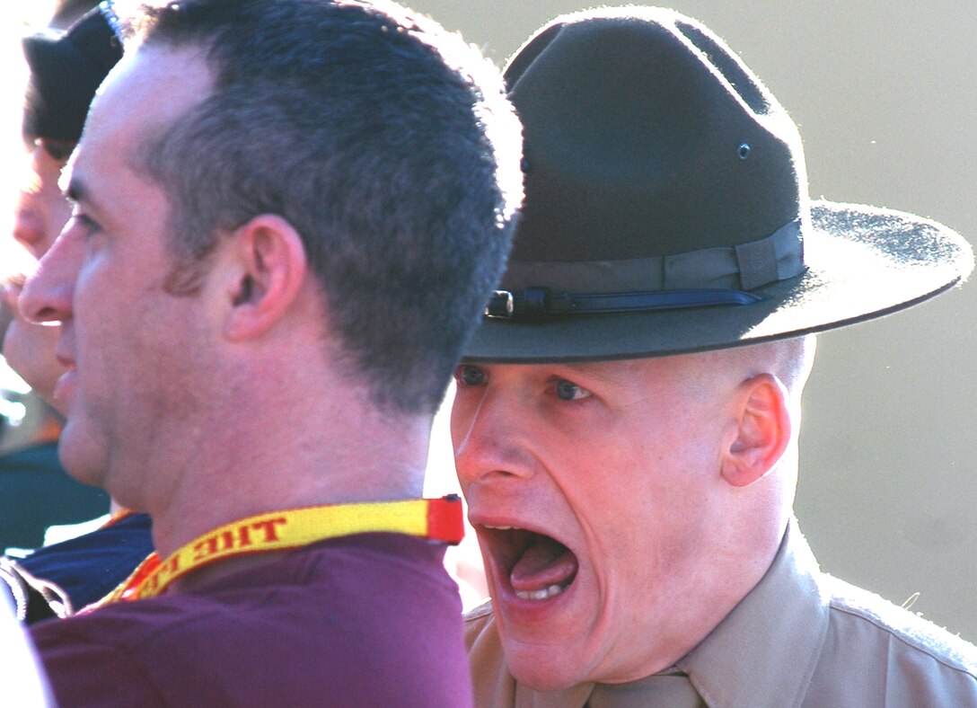 Daniel Casey, a counselor at Cesar Chavez High School in Laveen, Ariz., gets an ear full during his first few minutes on the famous yellow footprints of the depot’s Receiving Company, where all new recruits are greeted and welcomed to Marine Corps recruit training. The drill instructor handling Casey’s welcome is Sgt. Justin L. Hansen of Receiving Company. Educators from Recruiting Stations Denver and Phoenix finished their week-long visit to the Depot today.