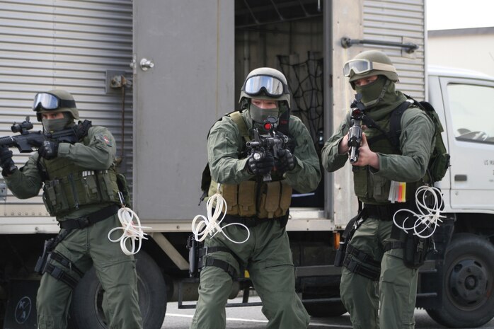 The Provost Marshal’s Office Special Reaction Team performs a walkthrough of the fire training tower using chalklines to simulate the tower’s layout as the SRT participates in a simulation during exercise Active Shield here March 2. The SRT stormed the building while the Japan Ground Self-Defense Force served as an extraction team during the simulation.