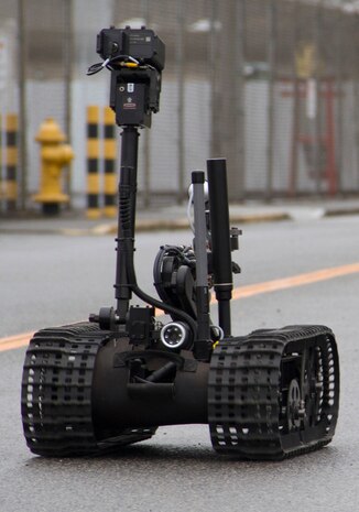 Exlposive Ordnance Disposal technicians use a robot to retrieve a suspicious package found during a bomb threat scenario at the northside Post Office during exercise Active Shield 2011 here March 1.