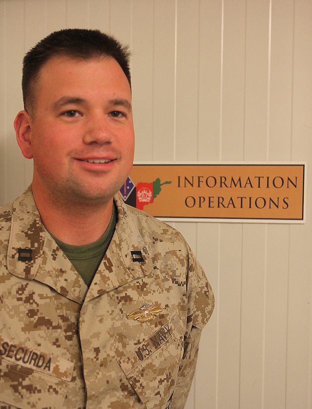 Atlanta native Navy Lt. John Securda proudly wears his Fleet Marine Force Qualified Officer insignia. The information operations planner earned his FMFQO insignia recently by successfully completing the necessary requirements, to include a six-mile hike, passing the Marine Corps Physical Fitness Test, completing a written test, and an oral board conducted by FMF-qualified officers. Securda deployed with 1st Marine Division (Forward) and will now continue to serve with 2nd MarDiv (Fwd).