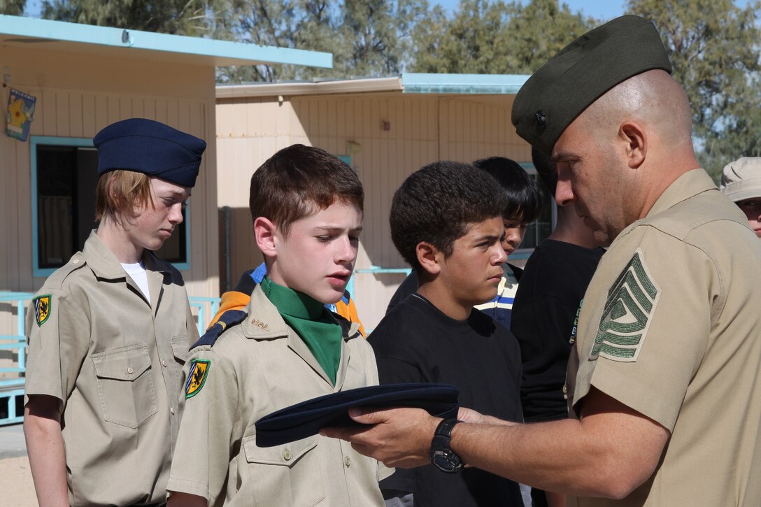First Sgt. Thomas Russi, first sergeant for Company A, Headquarters Battalion, asks a cadet about elements of the California Cadet Corps emblem on the student’s cover during a uniform inspection demonstration conducted at Twentynine Palms Junior High School.