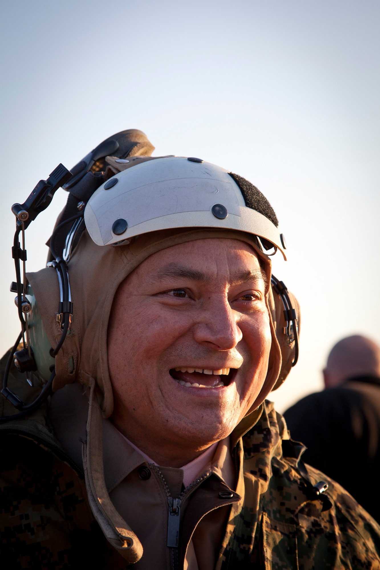 Gov. Eddie Baza Calvo of Guam is intrigued by an aviation cranial as he boards a helicopter at the Pentagon March 2, 2011. The governor and three Guam legislatures visited the Pentagon and toured Marine Corps Base Quantico, Va., to gather an understanding of the types of ranges planned for a new Marine Corps base on Guam. The live fire ranges planned for construction on Guam are a known distance (KD) rifle range, KD pistol range, 1000m automated multi-purpose machinegun (MPMG) range, modified record firing range (MRFR), 100m non-standard small arms range and live hand grenade range.