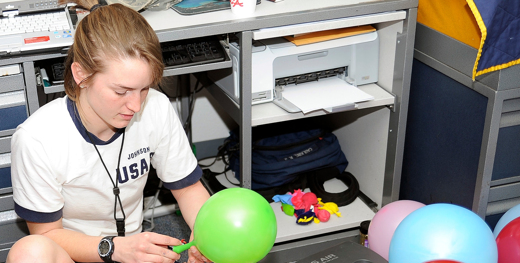 Cadet 4th Class Lindsay Johnson fills balloons in a senior's dormitory room during 100s Night at the Air Force Academy Feb. 16, 2011. Cadet Johnson is assigned to Cadet Squadron 02. Some of the balloons contained candy and other edibles. (U.S. Air Force photo/Megan Davis)