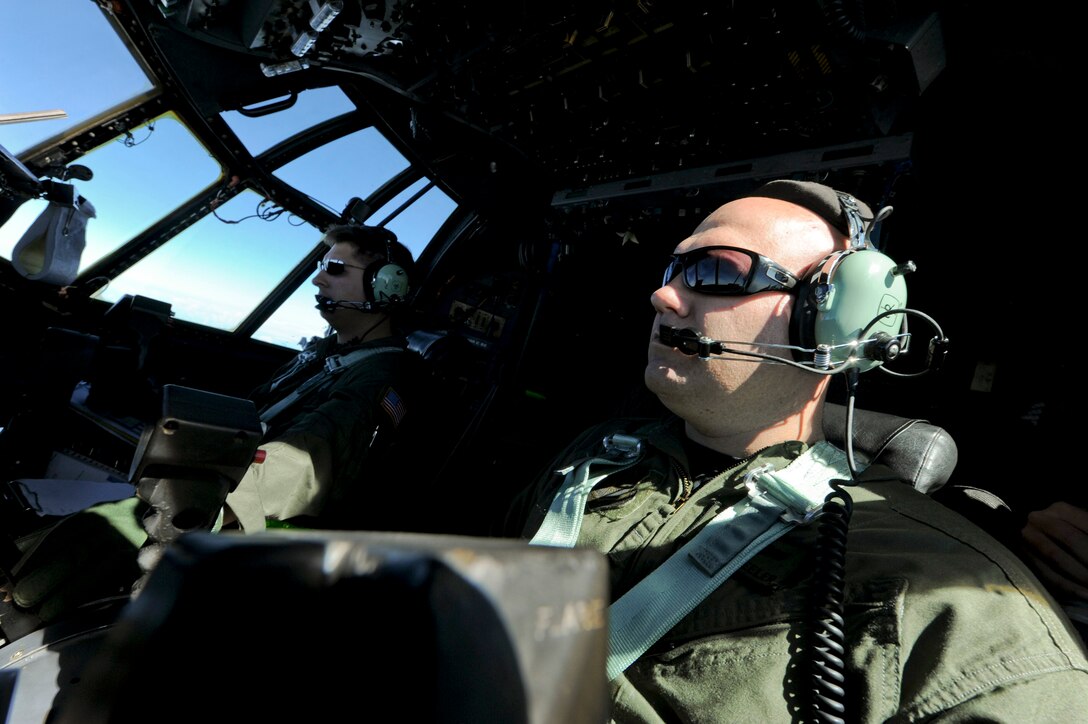 Capt. James Demis (left) and Maj. Darin Wheeler fly an MC-130H Combat Talon II en route to release a wreath Feb. 26, 2011, in memory of fallen brethren lost 30 years ago, when a 1st Special Operations Squadron MC-130E, call sign STRAY 59, crashed during an exercise, killing eight crewmembers and 15 passengers. Captain Demis and Major Wheeler are pilots with the1st SOS. (U.S. Air Force photo/Staff Sgt. Jonathan Steffen) 