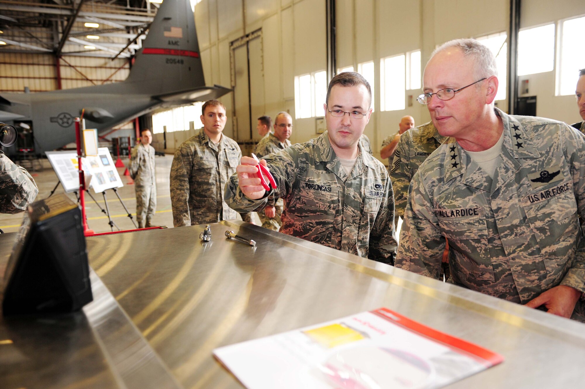 Senior Airman Christopher Torlincasi, a 19th Equipment Maintenance Squadron communications and navigation technician, demonstrates the capabilities of an automatic tool control box to Lt. Gen. Robert R. Allardice, 18th Air Force commander, Feb. 23, 2011, at Little Rock Force Base, Ark. General Allardice toured Little Rock Air Force Base to speak with members of Team Little Rock and see the mission first hand. (Photo by U.S. Air Force Senior Airman Jim Araos)