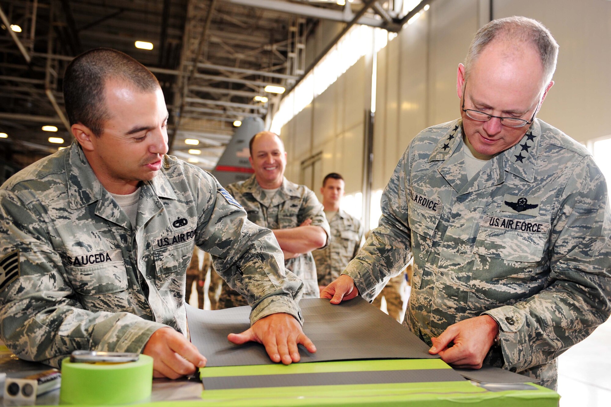 Staff Sgt. Adrian Sauceda, a 19th Equipment Maintenance Squadron corrosion control craftsman, shows Lt. Gen. Robert R. Allardice, 18th Air Force commander, how polyurethane protective tape is used to protect the belly of a C-130 Feb. 23, 2011, at Little Rock Force Base, Ark. General Allardice toured Little Rock Air Force Base to speak with members of Team Little Rock and see the mission first hand. (Photo by U.S. Air Force Senior Airman Jim Araos)