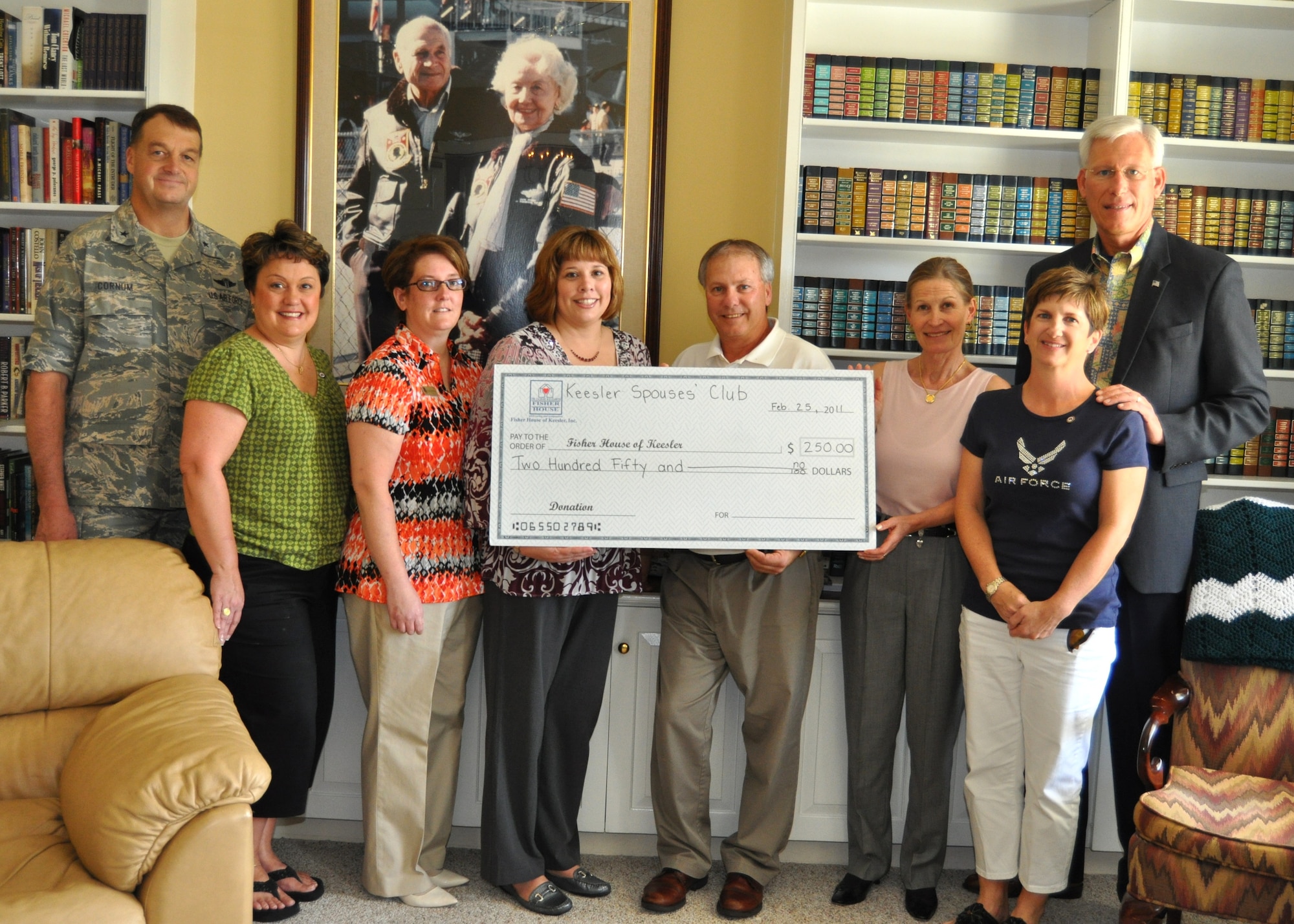 Keri Mueller, Keesler Spouses Club member and wife of 81st Training Wing
Commander Brig. Gen. Andrew Mueller, presents a $250 donation to Audrey Fisher on behalf of the organization to the Keesler Fisher House Feb. 25.  Mr. Vetter is director of Keesler Fisher House and Ms. Fisher is vice chairman of the Fisher House Foundation board of trustees.  From left, others pictured are Brig. Gen. (Dr.) Kory Cornum, 81st Medical Group commander; Leanne Ramsay, wife of former 81st Training Group deputy commander Lt. Col. Steven Ramsay; Vicki Downing, wife of 81st Training Wing vice commander Col. Glen Downing; Mary Fitzgerald, wife of Col. Jay Fitzgerald, 2nd Air Force; and retired Chief Master Sgt. Herm Hertog,
husband of 2nd Air Force Commander Maj. Gen. Mary Kay Hertog.  Mrs. Fisher
stopped by the Keesler Fisher House as part of regular visits she makes to the more than 50 Fisher Houses located throughout the U.S. and Germany.  She also was shown the 81st MDG Hospital's radiation oncology clinic since many Fisher House residents are patients or families of patients undergoing treatment there.  (U.S. Air Force photo by Steve Pivnick)
