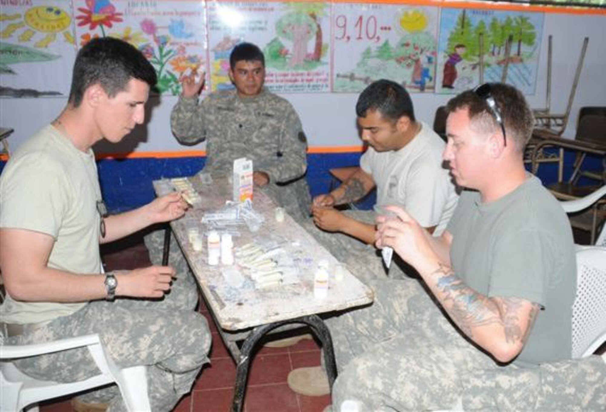 SOTO CANO AIR BASE, Honduras - Members of the Joint Task Force-Bravo 1-228th Aviation Regiment mix de-wormer medication for patients in Jucuaran Village, El Salvador, during a Medical Readiness Training Exercise Feb. 27.  More than 30 JTF-Bravo members provided aid to 1600 people, obtaining training and experience in delivering medical care in austere conditions, promoting diplomatic relations, and providing humanitarian and civic assistance. (U.S. Air Force photo/Staff Sgt. Kimberly Rae Moore)