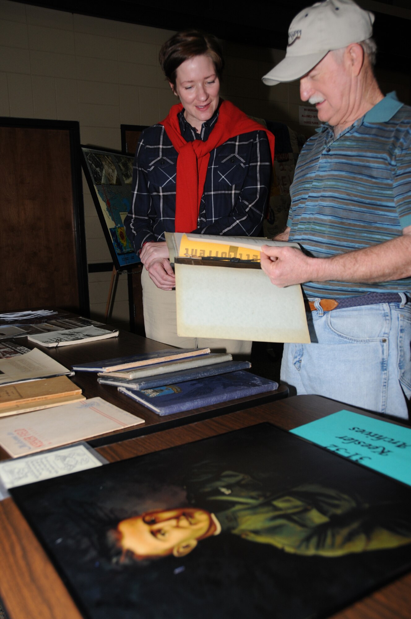 Base historian Susan Dawson chats with Wayne Hopkins of D’Iberville as they look at memorabilia from the Keesler archives at the Biloxi Community Center as part of the 21st annual Mississippi Coast History Week.  (U.S. Air Force photo by Kemberly Groue)