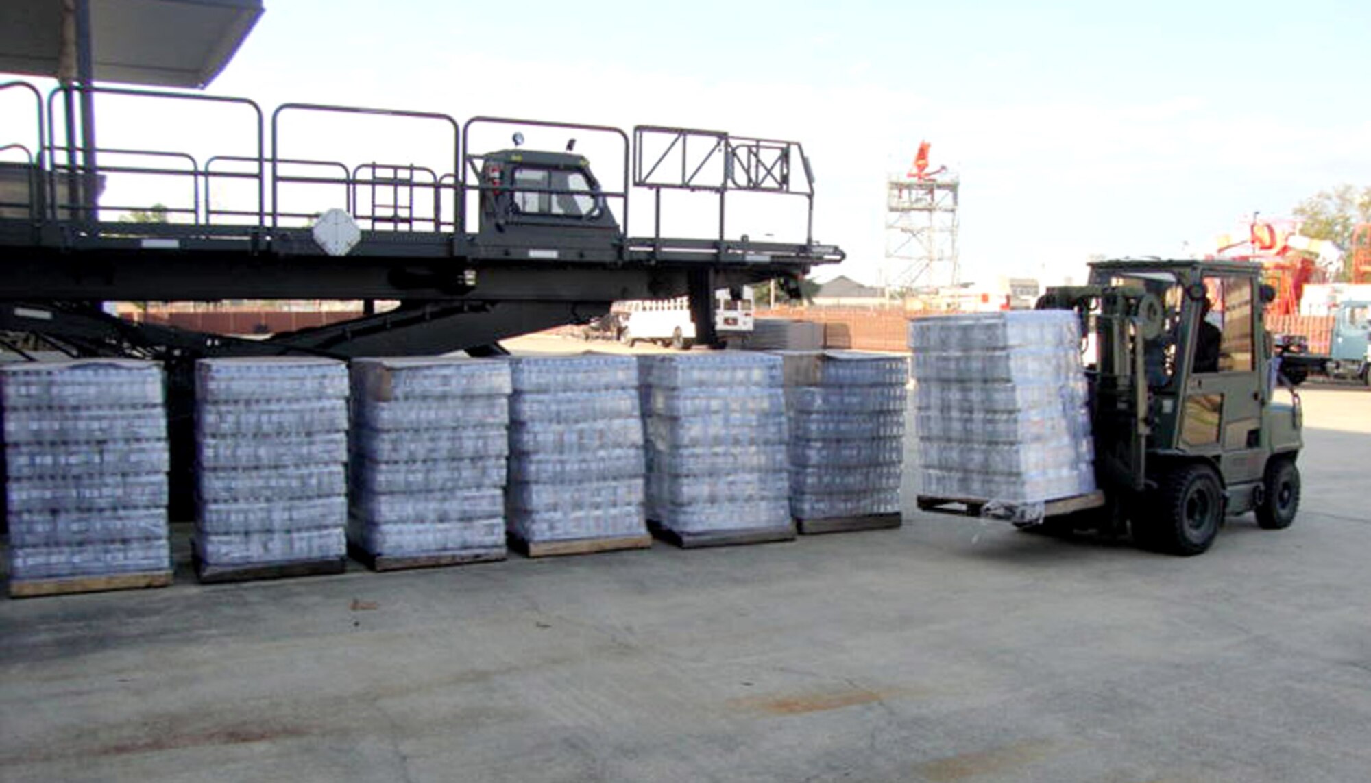 Forklift operator Gary Harmon unloads cases of water from a Pascagoula distributor at the Taylor Logistics Center Feb. 23. As of Monday, purchase of 7,660 cases or 162,192 bottles valued at $43,000 had been expedited by Airman 1st Class Ryan Zaremba.  (U.S. Air Force photo by Lt. Col. Jonathan Wright)