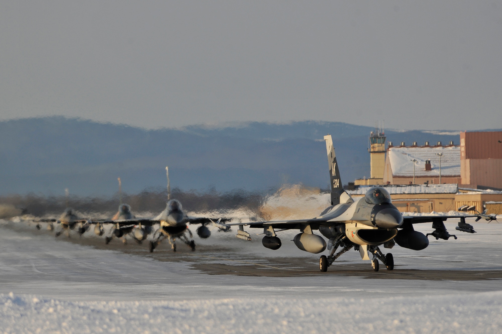 F-16 Fighting Falcon Aggressors taxi on the flightline March 1, 2011, Eielson Air Force Base, Alaska. The Aggressors returned from Andersen Air Force Base, Guam after participating in a two week long exercise conducted by the U.S. and Japan. (U.S. Air Force photo/Staff Sgt. Christopher Boitz)
