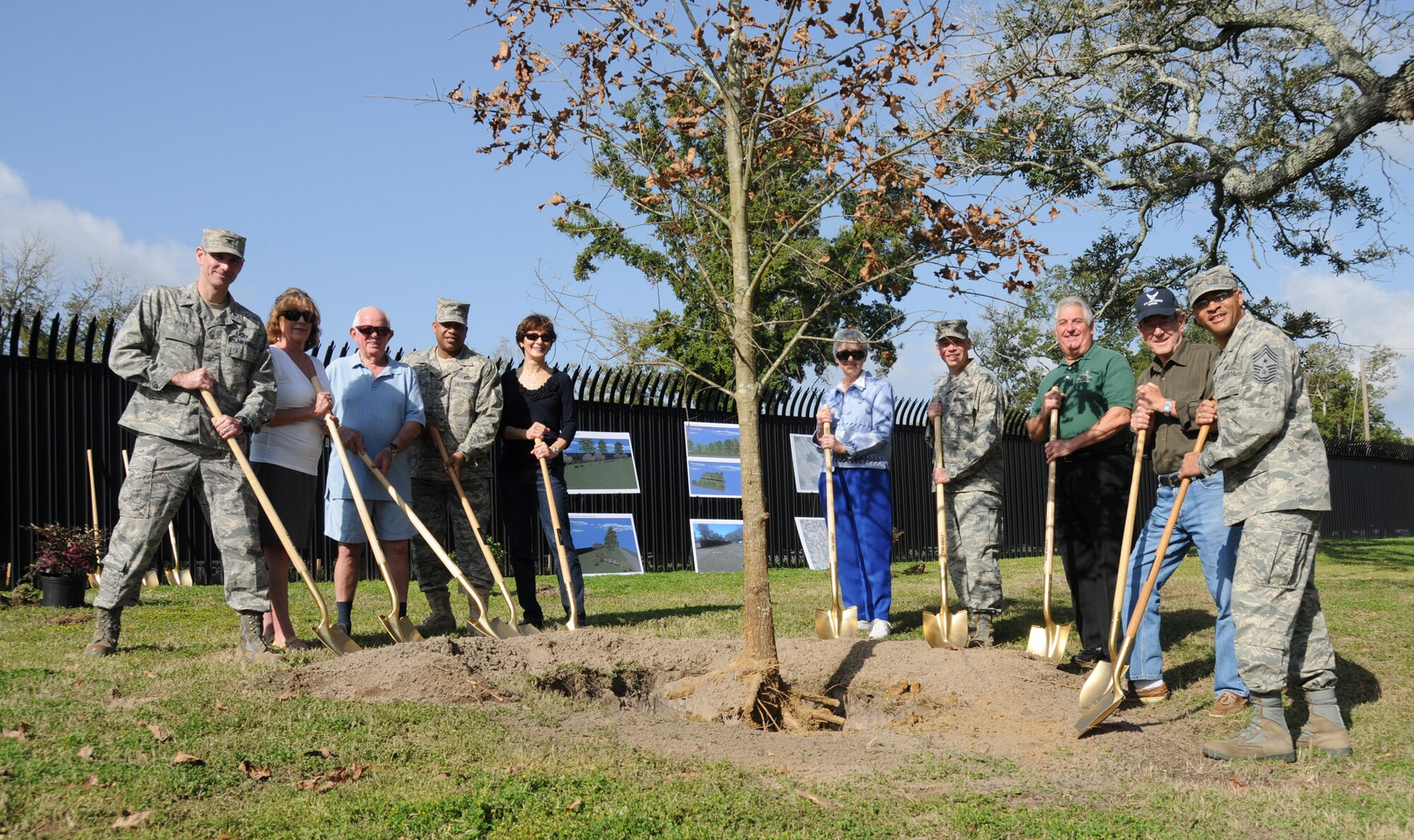 From left, Col. Rodney Berk, 81st Mission Support Group commander; Polly Ladner, president of the Oak Park Garden Club; Bob Young, Oak Park resident; Chief Master Sgt. Curtis Jennings, 81st MSG superintendent; Terese Collins, Oak Park resident; May
Young, Oak Park resident and master gardener; Col. Glen Downing, 81st Training Wing vice commander; George Lawrence, Biloxi City Council member; J.J. Vollmuth,
a retired chief master sergeant and Oak Park resident; and Chief Master Sgt. Lonnie Slater, 81st TRW command chief, participate in Friday’s tree planting ceremony at the entrance to the Oak Park neighborhood. The tree planting is part of a  comprehensive landscaping project to beautify the entrance into the Oak Park neighborhood just north of the base.  (U.S. Air Force photo by Kemberly Groue)