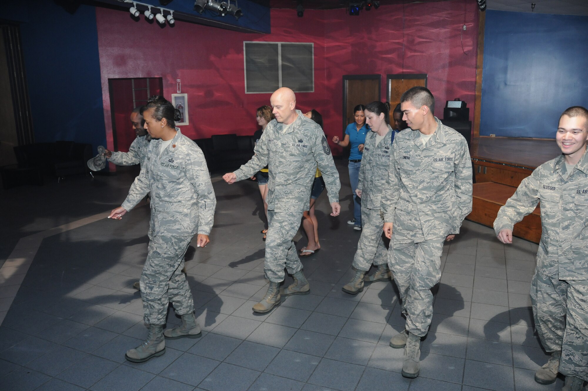 From left, Maj.Tabetha Clark, 335thTRS commander; Chief Master Sgt. Billy Abbott, 81st Training Group superintendent; Tech. Sgt. Julie Hammond, 81st TRG military training leader; and Airmen Basic Anthony Oneha and Francis Slusser, 332nd TRS students, dance to The Cupid Shuffle.  (U.S. Air Force photo by Kemberly Groue)
