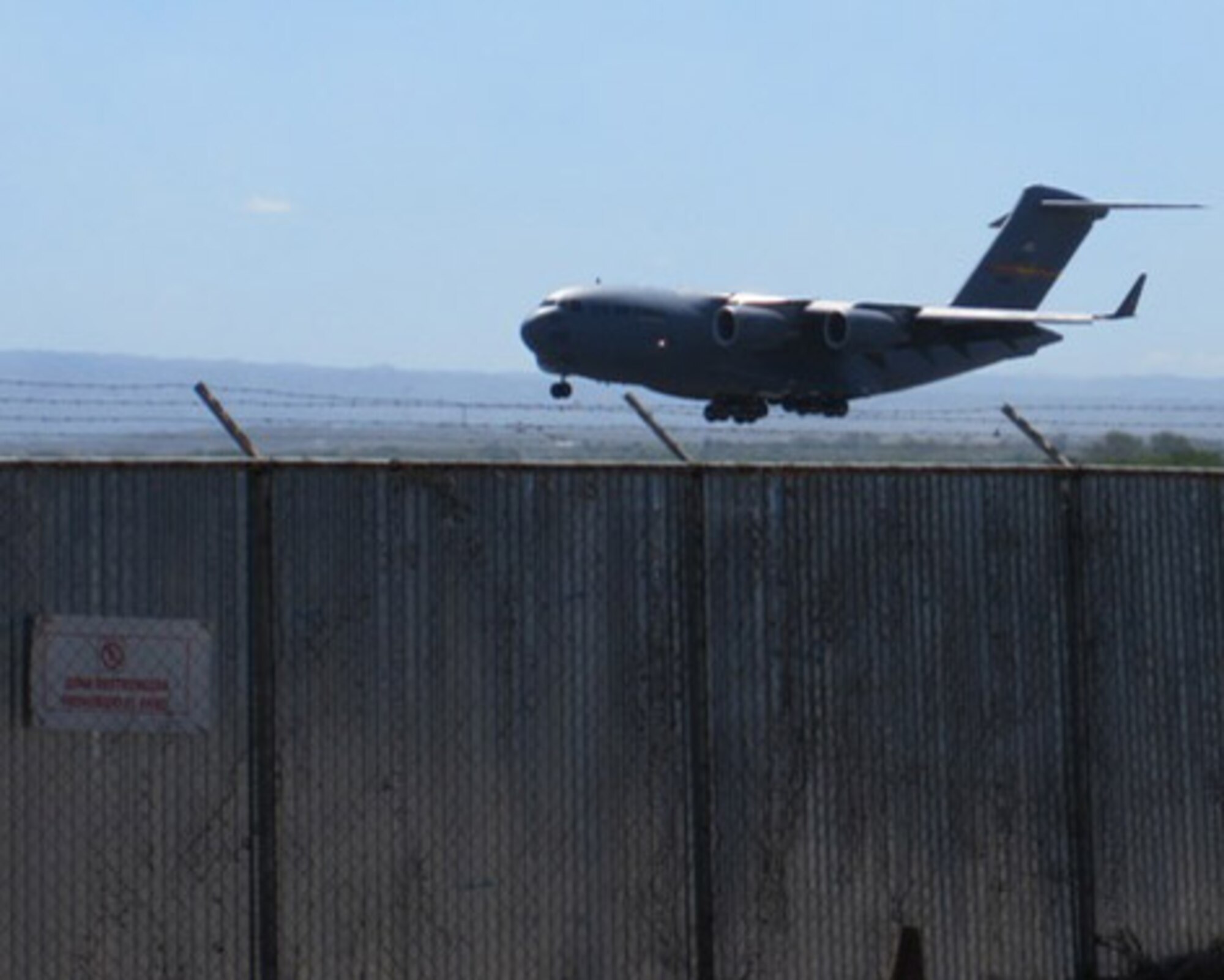 ALTUS AIR FORCE BASE, Okla. -- A C-17 Globemaster III from Altus AFB lands at Managua Airport, Nicaragua, Feb. 20, to deliver pallets of food and school supplies in support of humanitarian operations. The delivery of the donations was made possible because of the Denton Program, which allows for the transport of humanitarian goods on a space available basis using U.S. military transportation. (Courtesy Photo)           