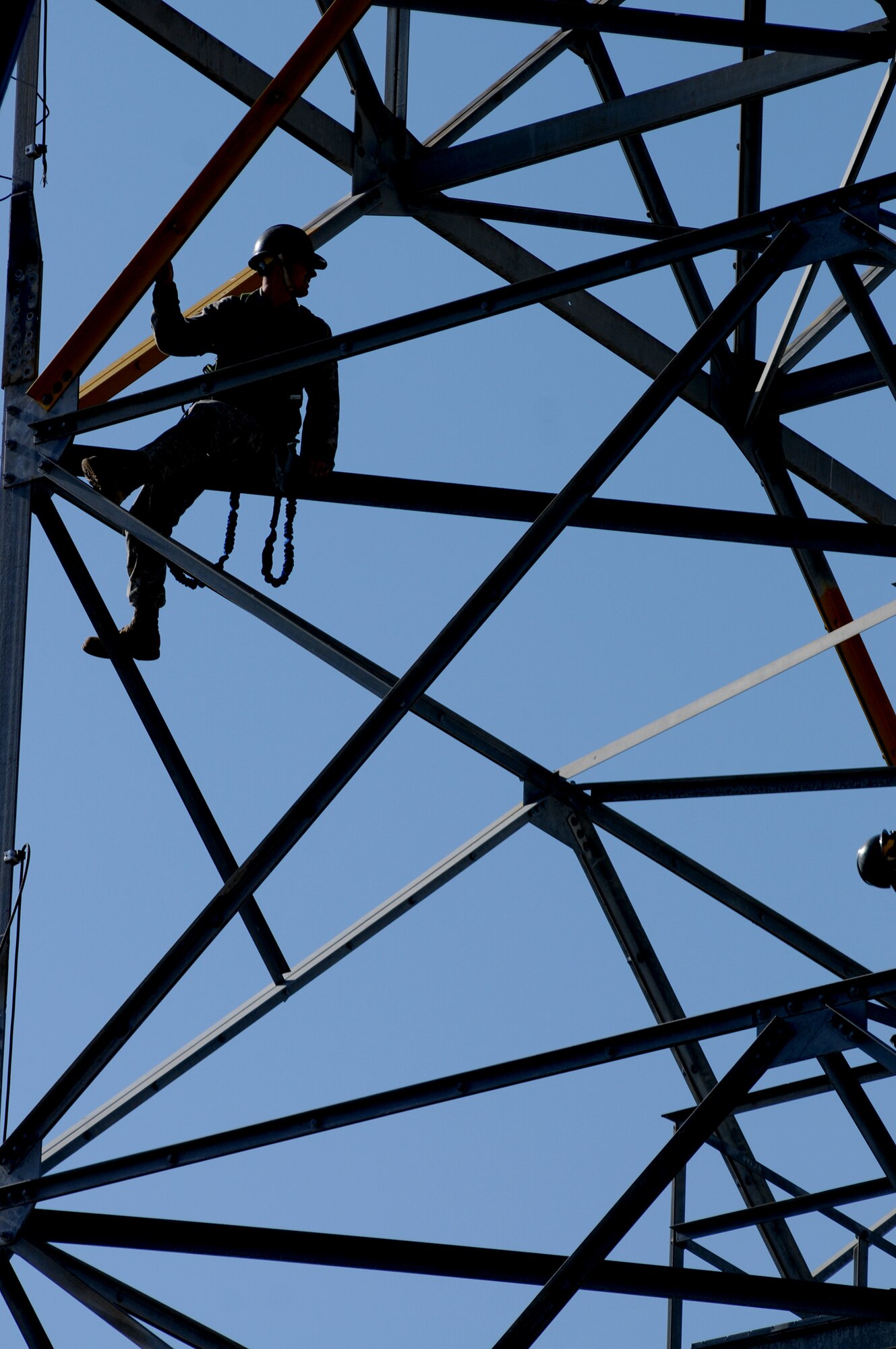 Senior Airman Jeremy Thatcher, 85th Engineering Installation Squadron, communicates with other team members Feb. 15 as they remove angle bolt plates from tower legs of an excess AN/GPN-20 (V) antenna south of Cody Hall. The tower was dismantled and returned to the supply system via Tobyhanna Army Depot, Pa. The system is valued at more than $436,000.  Having the system dismantled by the 85th EIS saved the Air Force money while providing a training opportunity for squadron members.  (U.S. Air Force photo by Kemberly Groue)