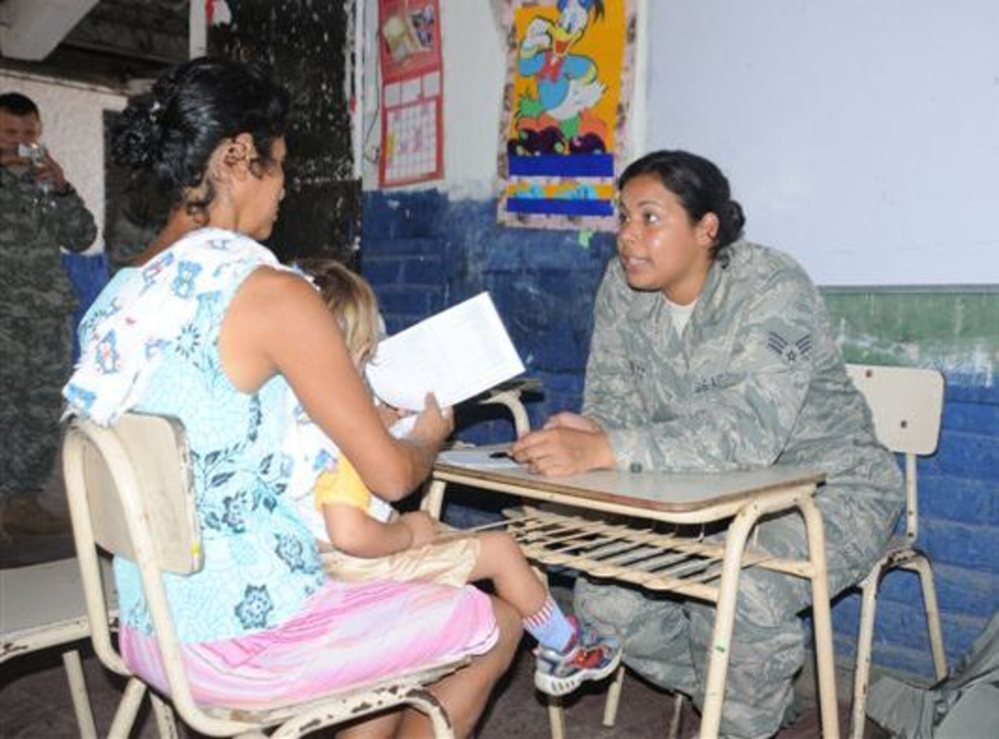 SOTO CANO AIR BASE, Honduras - Senior Airman Maria Barrett, Joint Task Force-Bravo medical technician, screens a patient at Canton El Espino, El Salvador, during a Medical Readiness Training Exercise Feb. 26.  More than 30 JTF-Bravo members provided aid to 1600 people, obtaining training and experience in delivering medical care in austere conditions, promoting diplomatic relations, and providing humanitarian and civic assistance.  (U.S. Air Force photo/Staff Sgt. Kimberly Rae Moore)