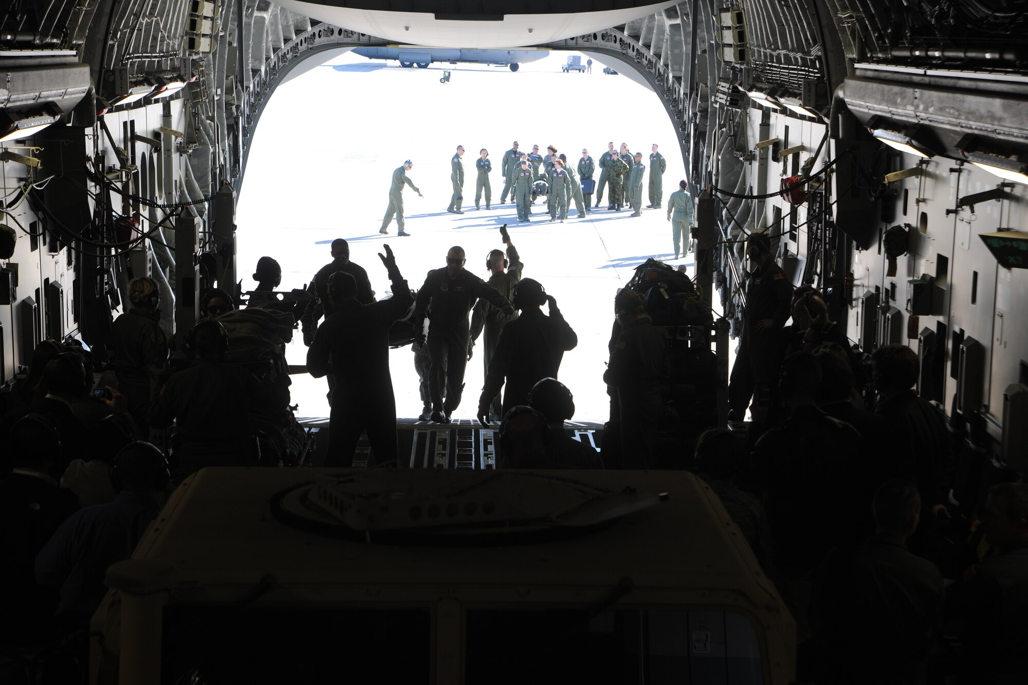 As Congressional staff members watch, members of the 375th Aeromedical Evacuation Squadron load simulated patients aboard a C-17 Globemaster III on Feb. 18, 2011, at Scott Air Force Base, Ill. The Congressional staff members had the opportunity to see first-hand airlift, airdrop and aeromedical aspects of Air Mobility Command’s mission. (U.S. Air Force Photo/Master Sgt. Jeff Capenos)