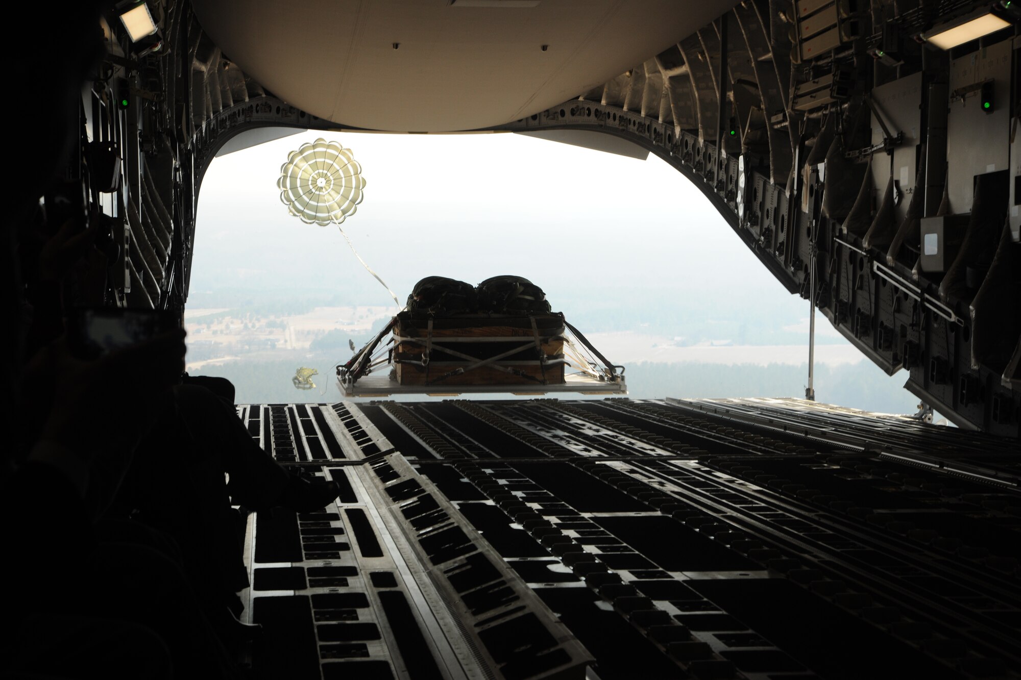 A pallet exits a 14th Airlift Squadron C-17 Globemaster III over North Field, Joint Base Charleston, S.C., on Feb. 18, 2011, during an orientation flight for Congressional staff members. The Congressional staffers spent the day learning about airlift, airdrop and aeromedical evacuation as part of an orientation designed to give them a better understand of Air Mobility Command’s mission. (U.S. Air Force Photo/Master Sgt. Jeff Capenos)
