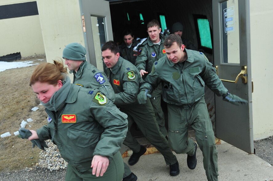 MINOT AIR FORCE BASE, N.D. – Members of the 23rd Bomb Squadron rush to their vehicles during a rapid response as part of a recent operation readiness exercise, here Mar. 2. Exercises like these are conducted to ensure Team Minot operates in a safe, secure and reliable manner. (U.S. Air Force photo/Senior Airman Jesse Lopez)