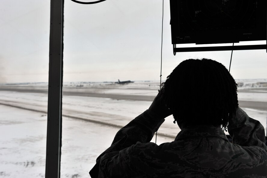 MINOT AIR FORCE BASE, N.D. -- Airman 1st Class Natalie Robinson, 5th Operational Support Squadron air traffic controller, watches as a B-52H Stratofortress aircraft launch during a recent operational readiness exercise, here Mar. 2. Team Minot conducts these kinds of exercises to ensure safe, secure, and reliable operations.  (U.S. Air Force photo/Staff Sgt. Keith Ballard)