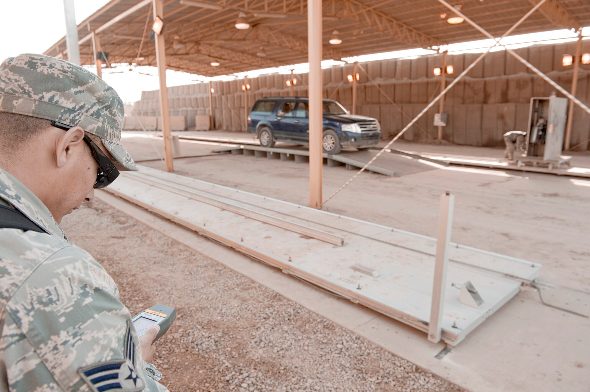 Senior Airman David Leon checks radiation levels of the area around the relocatable Vehicle and Cargo Inspection System Feb. 22, 2011, during training at Sather Air Base, Iraq. The VACIS is a recent addition to the Sather Air Base vehicle inspection arsenal and increases the capability to provide security to the base. Airman Leon is assigned to the 447th Expeditionary Security Forces Squadron. (U.S. Air Force photo/Staff Sgt. Levi Riendeau) 