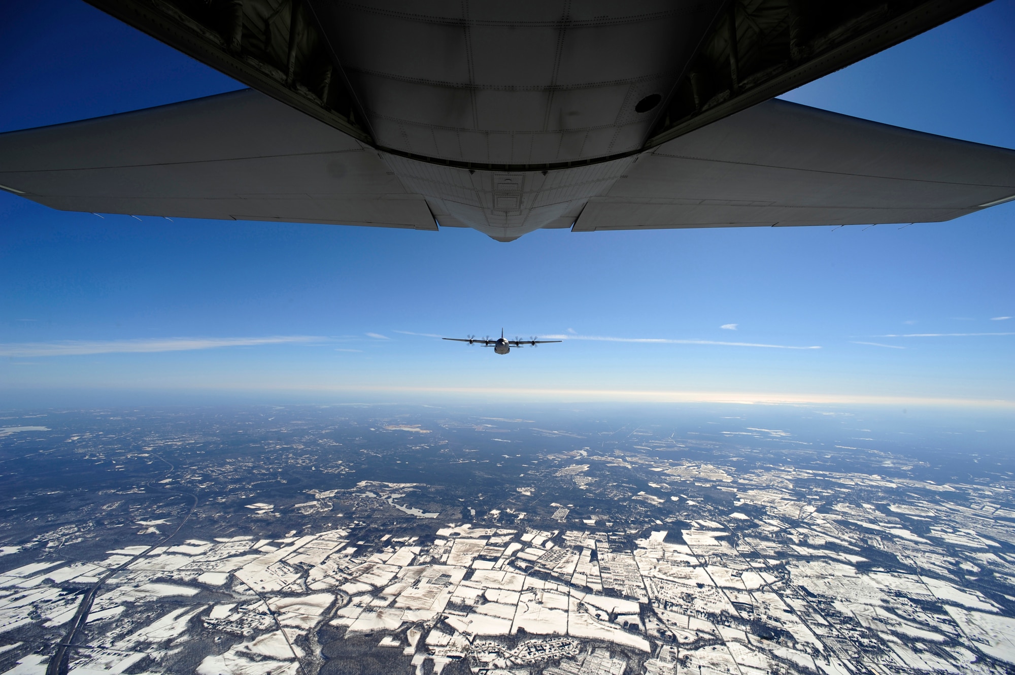 An EC-130J Commando Solo from the 193rd Special Operations Squadron flown by Air Force Special Operations Training Center students class 1101 flies in formation Feb. 11, 2011, over Harrisburg, Pa., during a training sortie. Class 1101 is the first group of students to attend mission qualification training for the EC-130J that will replace all the E- and P-model aircraft within the next few years. The EC-130J is equipped with modern avionics and mission systems. It is expected to provide specialized mobility to combatant commanders. (U.S. Air Force photo/Staff Sgt. Julianne M. Showalter) 