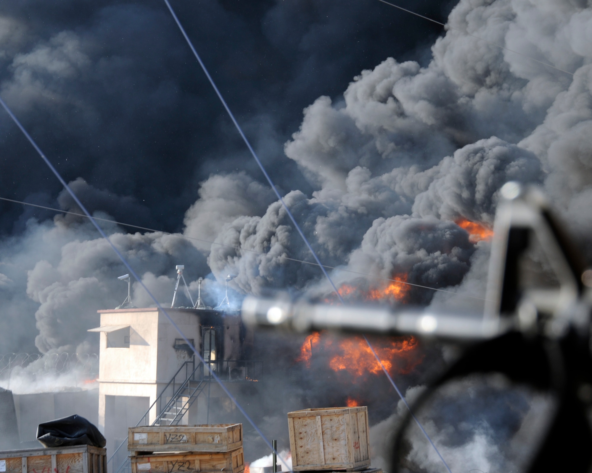Smoke billows after a mortar and small arms attack captured by deployed photographer Senior Airman Chanise Epps. (U.S. Air Force photo/Senior Airman Chanise Epps)
