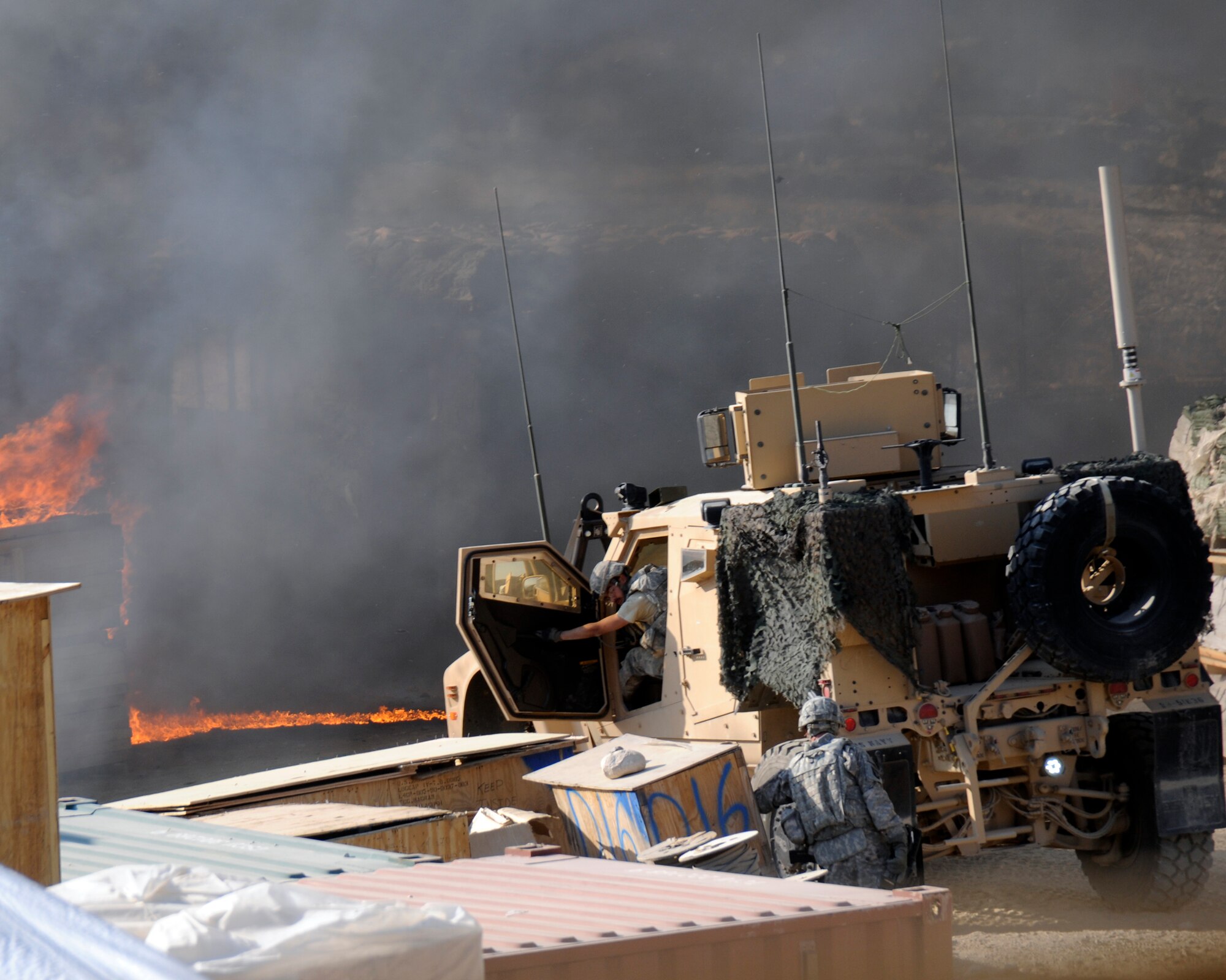 Photographer Senior Airman Chanise Epps captures soldiers involved in a mortar and small arms attack on their forward operation base in Afghanistan. Airman Epps was deployed as part of a Provisional Construction Team. (U.S. Air Force photo/Senior Airman Chanise Epps)