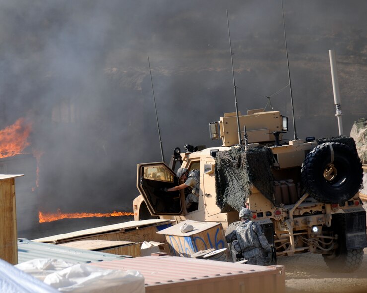 Photographer Senior Airman Chanise Epps captures soldiers involved in a mortar and small arms attack on their forward operation base in Afghanistan. Airman Epps was deployed as part of a Provisional Construction Team. (U.S. Air Force photo/Senior Airman Chanise Epps)