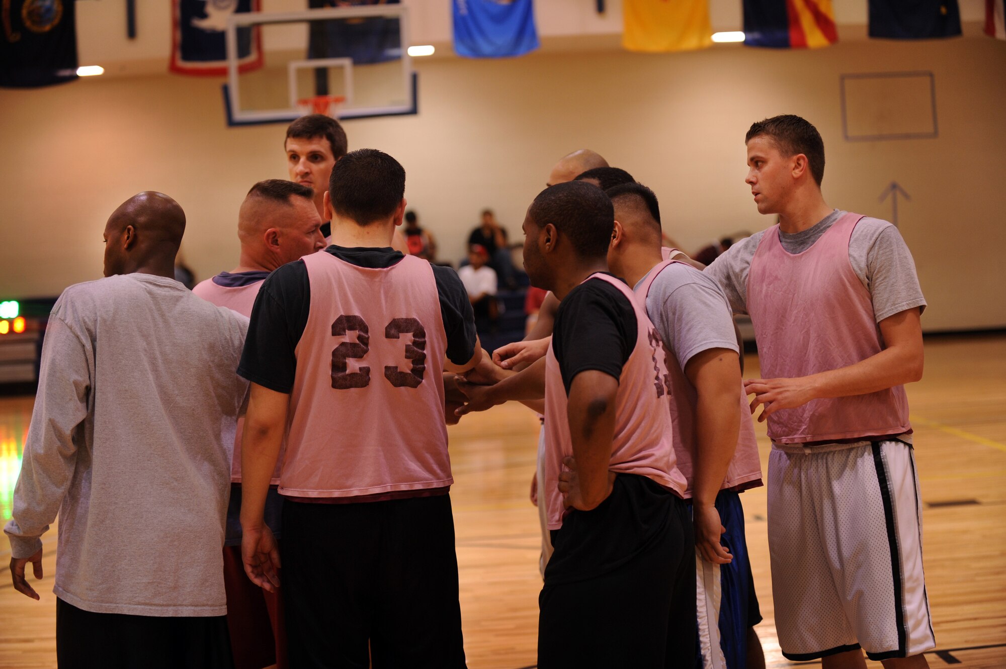 MOODY AIR FORCE BASE, Ga. -- Team members from the 23rd Medical Group form a huddle to discuss a way to secure the win in the second half during halftime of an intramural basketball game Mar. 1. At the end of the first half, the 23rd MDG was in the lead with a score of 30-17. (U.S. Air Force photo/Airman 1st Class Douglas Ellis)(RELEASED)
