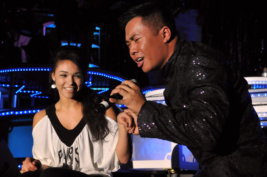 MINOT, N.D. – Staff Sgt. Harron Elloso, Tops in Blue vocalist, serenades a member of the audience during a Tops in Blue performance at the State Fair Grounds here Feb. 23. Tops in Blue serves as an expeditionary entertainment unit to provide quality entertainment from within Air Force resources for the Air Force family and personnel. (U.S. Air Force photo/Airman 1st Class Jessica McConnell)