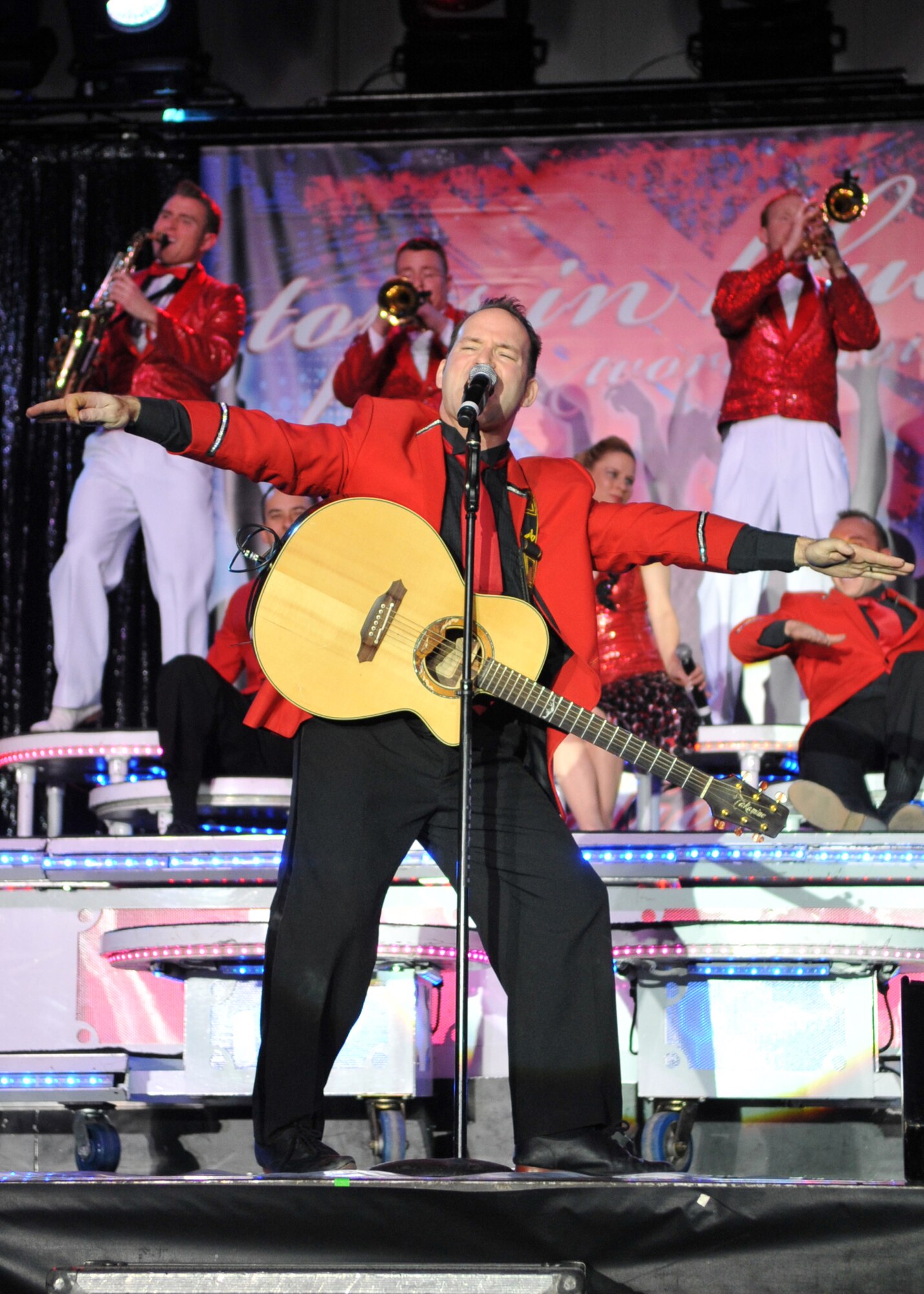 MINOT, N.D. – Master Sgt. Robert Clark, Tops in Blue vocalist and first sergeant, performs during a Tops in Blue performance at the State Fair Grounds here Feb. 23. Tops in Blue serves as an expeditionary entertainment unit to provide quality entertainment from within Air Force resources for the Air Force family and personnel. (U.S. Air Force photo/Airman 1st Class Jessica McConnell)