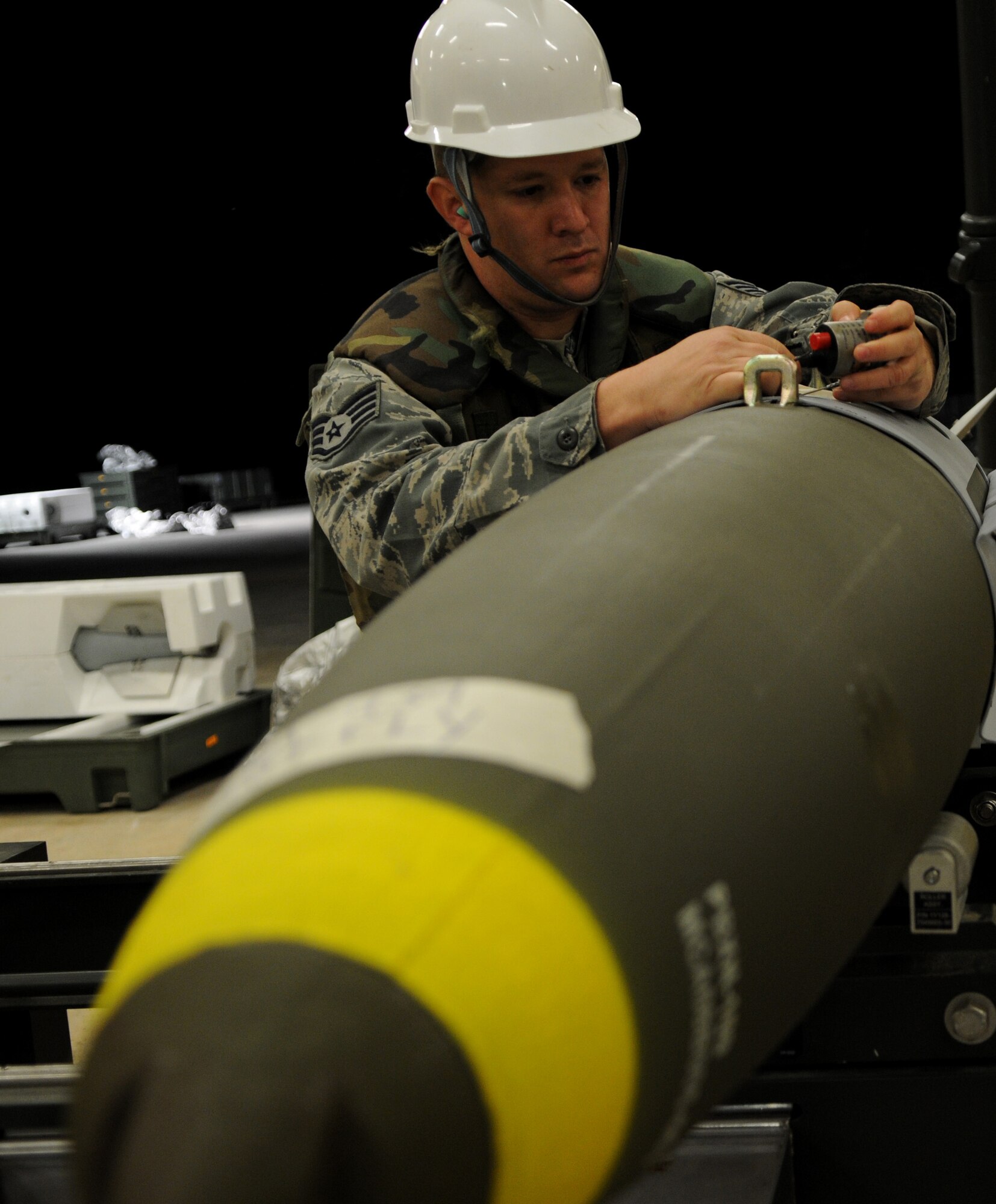Staff Sgt. Matthew Owen, 18th Munitions Squadron munition systems craftsman, removes a fuse initiator from a Mark 83 bomb body during Beverly High 11-03, a local operational readiness exercise, on Kadena Air Base, Japan, March 3. During the exercise, Kadena Airmen tested their abilities to deploy to and operate in a contingency environment. (U.S. Air Force photo/Airman 1st Class Jarvie Z. Wallace)