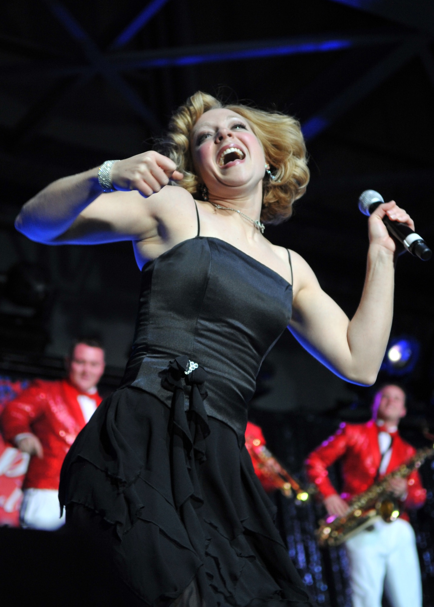 MINOT, N.D. – Tech. Sgt. Lesley Hunter, Tops in Blue vocalist, performs for the Minot community during a Tops in Blue performance at the State Fair Grounds here Feb. 23. Tops in Blue serves as an expeditionary entertainment unit to provide quality entertainment from within Air Force resources for the Air Force family and personnel. (U.S. Air Force photo/Airman 1st Class Jessica McConnell)