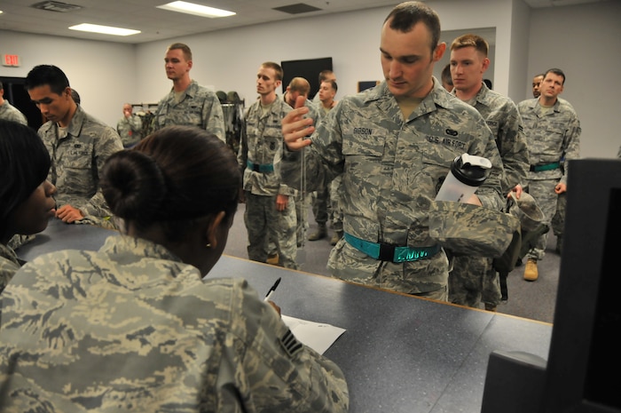 Airmen participating in a mobility exercise check in to the 628th Logistics Readiness Squadron and show their dog tags Feb. 24. This was the second mobility exercise in preparation for the upcoming Operational Readiness Inspection. (U.S. Air Force photo/Airman 1st Class Jared Trimarchi)