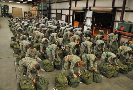 Airmen from Joint Base Charleston review their deployment bags to ensure all required items are present. They were participating in the mobility exercise conducted Feb. 24 through Feb. 26. (U.S. Air Force photo/ Airman 1st Class Jared Trimarchi)