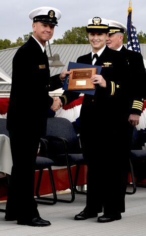 Lt. j.g. Chloe Gorski receives the class Honorman plaque, awarded to the graduate with the highest grade-point-average, from keynote speaker Command Master Chief Jerry Pittman, Naval Recruiting District Phoenix, Ariz., during the Naval Nuclear Power Training Command graduation ceremony at Joint Base Charleston-Weapons Station, Feb. 25. (U.S. Navy photo/Machinist’s Mate 3rd Class Brannon Deugan)