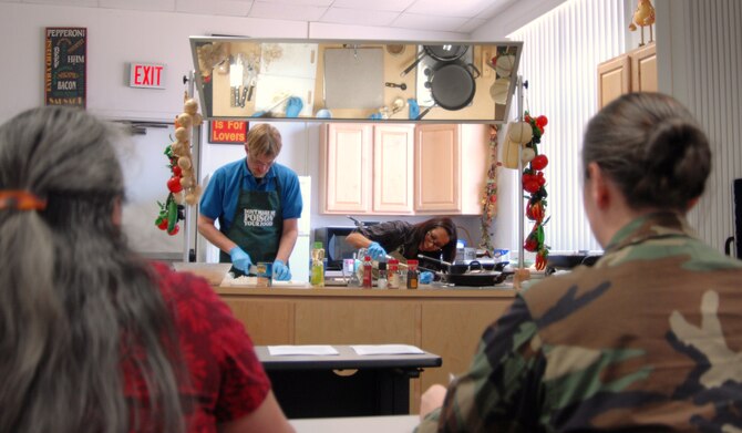 Kathleen Augustine, Air Force Flight Test Center financial management office (left) and Capt. Jennifer Van Well, an operations engineer in the 419th Flight Test Squadron, look on as they learn tasty ways to “Boost their Fiber.” The Health and Wellness Center hosted a fiber-themed cooking demonstration class, Feb. 24, for the base community to encourage a healthy lifestyle through nutritious meals. (Air Force by photo Kate Blais)