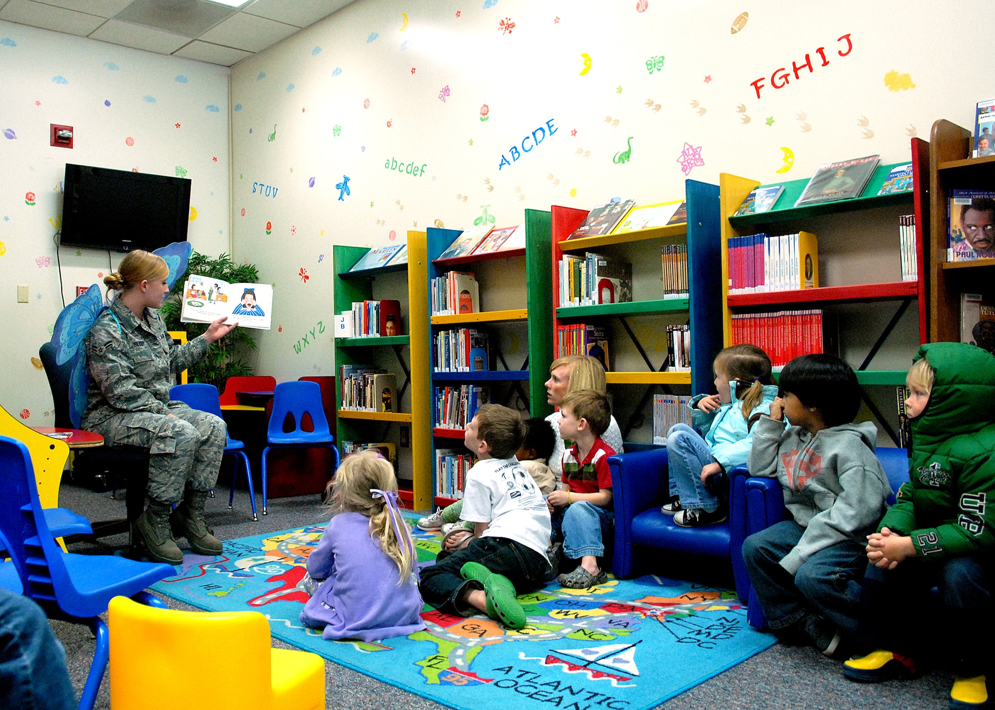 The “Tooth Fairy”, Airman 1st Class Danielle Slody, 95th Medical Group dental assistant, reads a book about a child’s trip to the dentist to a class from Little Hands Pre-School on Edwards. As part of National Children’s Dental Health Month, the 95th MDG dental office hosted two interactive, kid-friendly information sessions in the Children’s Library to promote good oral health among the base’s youngest population. (Air Force photo by Kate Blais)