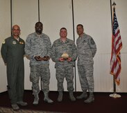 Col. Brian Robinson (left) and Chief Master Sgt. Terrence Greene (right) present Senior Airman Edric Byrd and Staff Sgt. Travis Meeks the Diamond Sharp award during a ceremony at the Charleston Club March 1. Colonel Robinson is the 437th Airlift Wing vice commander, Chief Greene is the 437th AW command chief, Sergeant Byrd is form the 437th Operations Support Squadron and Sgt. Meeks is from the 437th Aerial Port Squadron. Other Diamond Sharp winners not pictured are Senior Airman Frederick Jordan from the 14th Airlift Squadron and Senior Airman Luke Harshman from the 16th Airlift Squadron. Diamond Sharp awardees are Airmen chosen by their first sergeants for their excellent performance. (U.S. Air Force photo/Airman Jared Trimarchi)