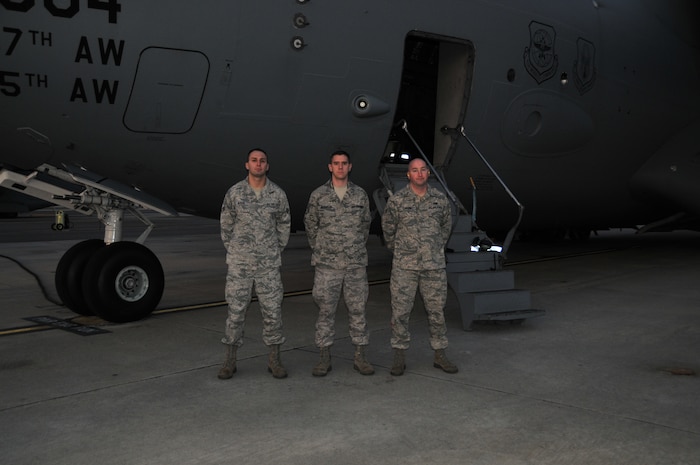 Senior Airman Jared Alessi, Staff Sgt. Jonathan Houghton and Senior Airman Grant Carson from the 437th Aircraft Maintenance Squadron pose in front of a C-17, Feb. 15. The three Airmen received medals for their acts of courage that lead to the apprehension of an intruder on Incirlik Air Bse, Turkey, in 2009. (U.S. Air Force photo/ Airman 1st Class Jared Trimarchi)