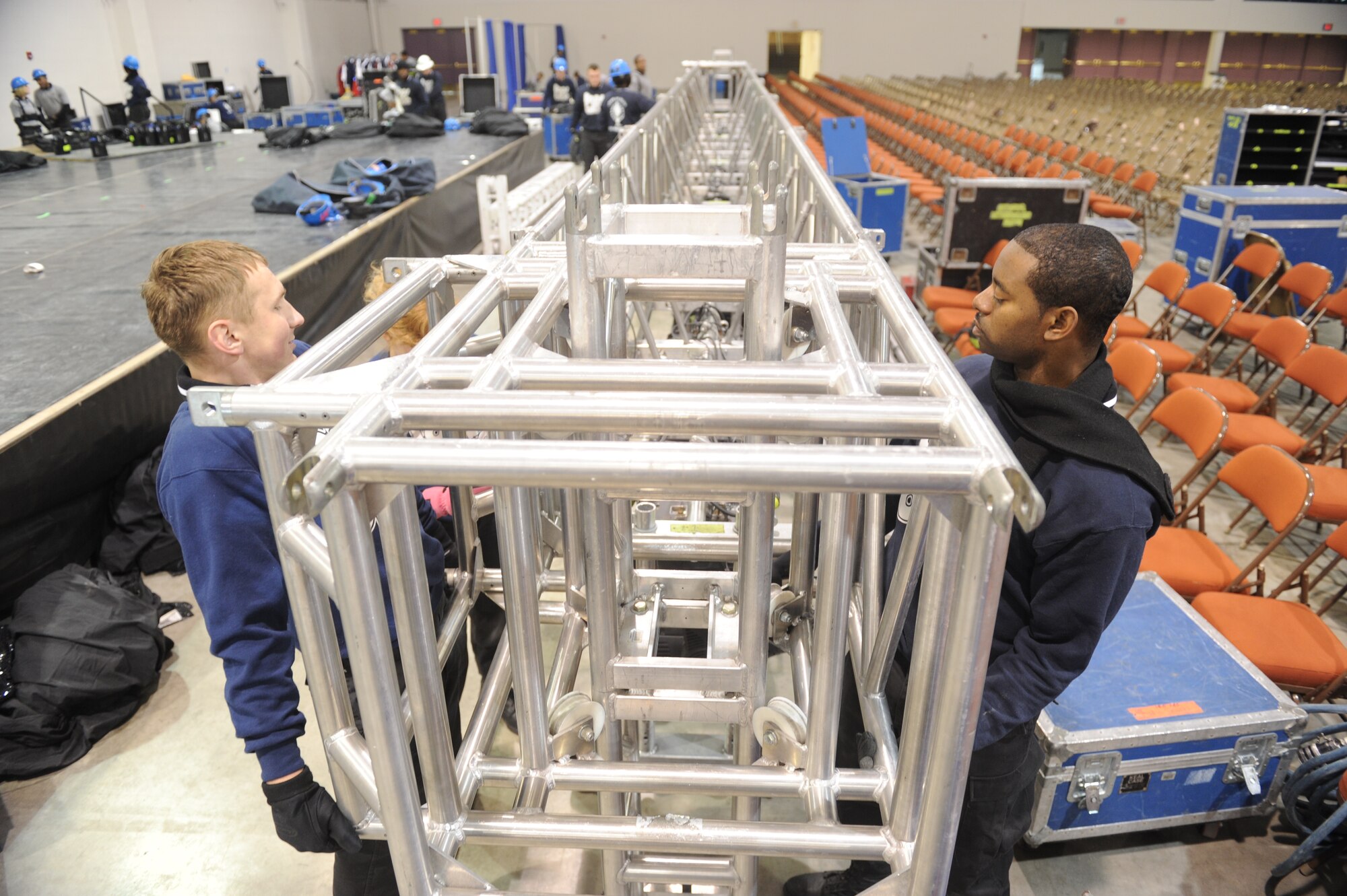MINOT, N.D. -- Senior Airman Jerry Kamysz, Tops in Blue lighting director, and Staff Sgt. Antonio Howard, Tops in Blue vocalist, set up for the Tops in Blue performance at the State Fair Grounds here Feb. 23. Tops in Blue serves as an expeditionary entertainment unit to provide quality entertainment from within Air Force resources for the Air Force family and personnel. (U.S. Air Force photo/Senior Airman Michael Veloz)