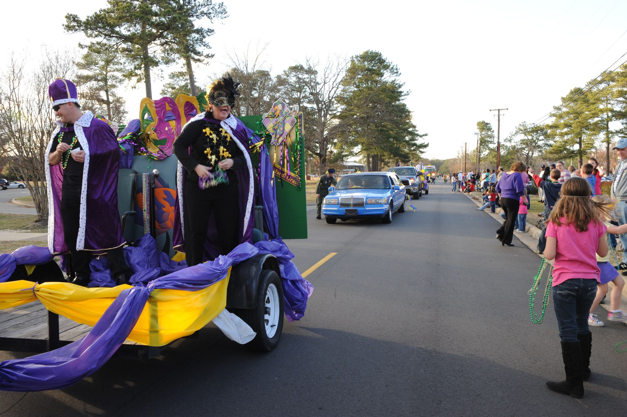SEYMOUR JOHNSON AIR FORCE BASE, N.C. -- Col.'s Shawn Pederson and Anne Winkler toss beads into the crowd during a Mardi Gras "Catch the Beads" parade, here Feb. 25, 2011. Colonel's Pederson and Winkler were Mardi Gras king and queen of the parade. Colonel Pederson is the 4th Fighter Wing vice commander. Colonel Winker is the 4th Mission Support Group commander.  (U.S. Air Force photo/Staff Sgt. Courtney Richardson) (RELEASED)