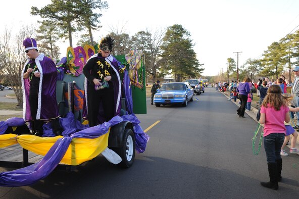 SEYMOUR JOHNSON AIR FORCE BASE, N.C. -- Col.'s Shawn Pederson and Anne Winkler toss beads into the crowd during a Mardi Gras "Catch the Beads" parade, here Feb. 25, 2011. Colonel's Pederson and Winkler were Mardi Gras king and queen of the parade. Colonel Pederson is the 4th Fighter Wing vice commander. Colonel Winker is the 4th Mission Support Group commander.  (U.S. Air Force photo/Staff Sgt. Courtney Richardson) (RELEASED)