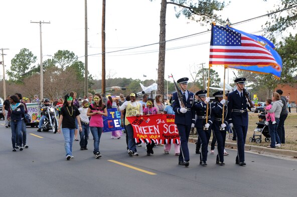 SEYMOUR JOHNSON AIR FORCE BASE, N.C. -- Members of the 4th Fighter Wing honor guard lead a Mardi Gras "Catch the Beads" parade, here Feb. 25, 2011. Various base organizations participated in a friendly float competition as well as tossing beads and candy to spectators. (U.S. Air Force photo/Staff Sgt. Courtney Richardson) (RELEASED)